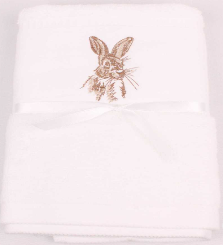 A folded white towel with a brown embroidered bunny design in the center and a white satin ribbon tied around the middle, shown on a plain white background.