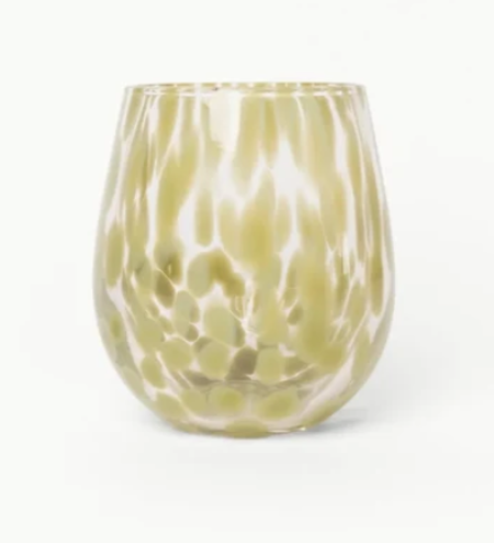 A stemless wine glass with a textured, hammered finish in a pale olive green and white marbled pattern, set against a plain white background.